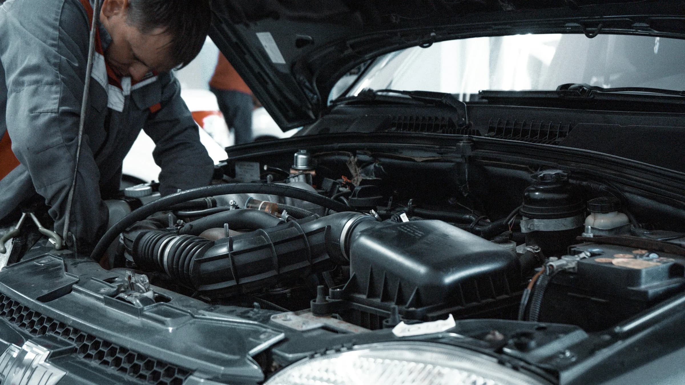 Mechanic working on a car engine — illustrative workshop photograph